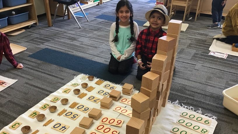 Two young children playing with blocks