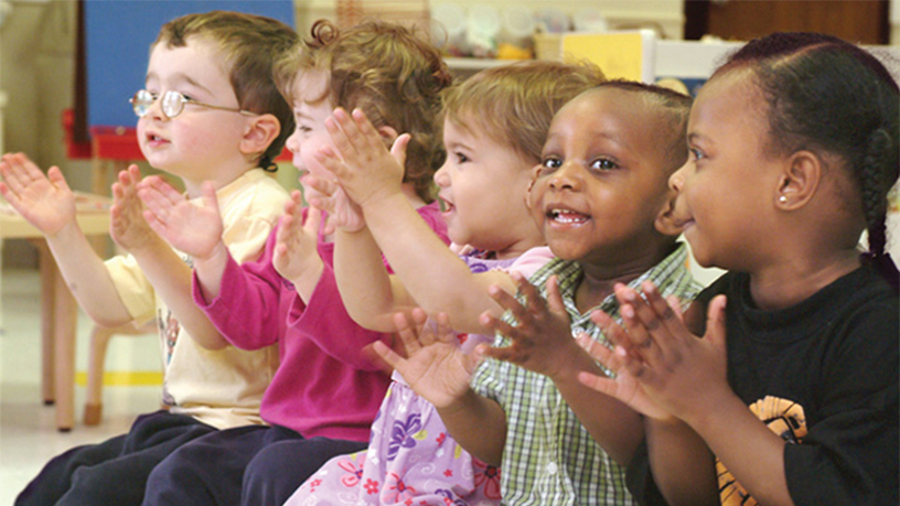 Young group of children singing and clapping