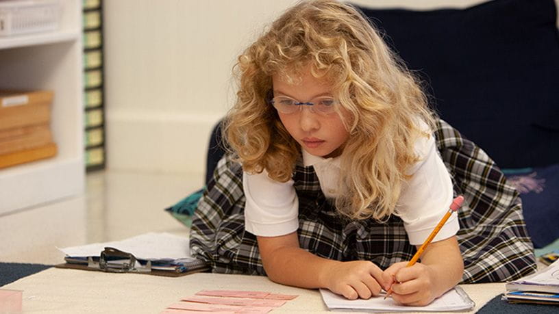 Young child writing in journal